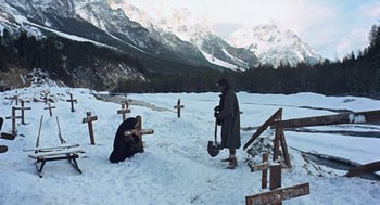 Movie still from “The Great Silence” (1968), directed by Sergio Corbucci – A man kneeling in the snow next to crosses; Wide shot, High angle