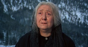 Movie still from “The Great Silence” (1968), directed by Sergio Corbucci – An older woman with a black scarf on her head; Close Up shot, Low angle