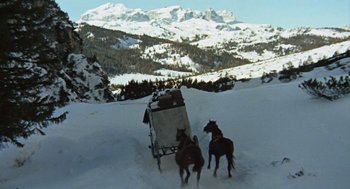 Movie still from “The Great Silence” (1968), directed by Sergio Corbucci – A horse drawn carriage traveling through the snow covered mountains; Wide shot, Low angle