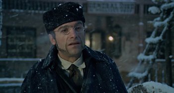 Movie still from “The Great Silence” (1968), directed by Sergio Corbucci – A man wearing a hat and glasses standing in the snow; Close Up shot, Low angle