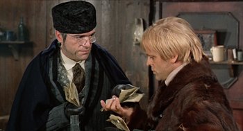 Movie still from “The Great Silence” (1968), directed by Sergio Corbucci – Two men are looking at a bundle of money; Close Up shot, Over the shoulder angle