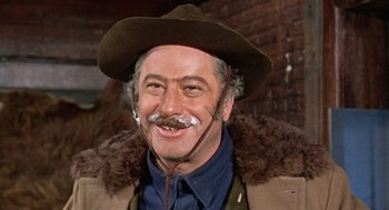 Movie still from “The Great Silence” (1968), directed by Sergio Corbucci – An older man wearing a hat and a mustache; Close Up shot, Low angle