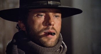 Movie still from “The Great Silence” (1968), directed by Sergio Corbucci – A person wearing a hat with a cigarette in his mouth; Close Up shot, Low angle