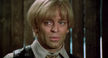 Movie still from “The Great Silence” (1968), directed by Sergio Corbucci – A person wearing a suit and tie; Close Up shot, Low angle