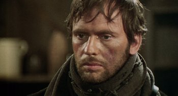 Movie still from “The Great Silence” (1968), directed by Sergio Corbucci – A person with a beard; Close Up shot, Over the shoulder angle