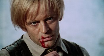 Movie still from “The Great Silence” (1968), directed by Sergio Corbucci – A person with blood on his face; Close Up shot, Low angle