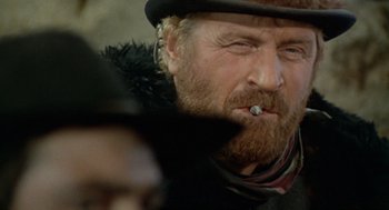 Movie still from “The Great Silence” (1968), directed by Sergio Corbucci – A person smoking a cigarette; Close Up shot, Low angle