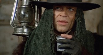 Movie still from “The Great Silence” (1968), directed by Sergio Corbucci – A person holding a cup of coffee; Close Up shot, Low angle