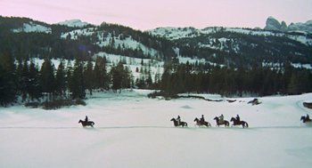 Movie still from “The Great Silence” (1968), directed by Sergio Corbucci – A group of people riding horses in the snow; Extreme Wide shot, High angle