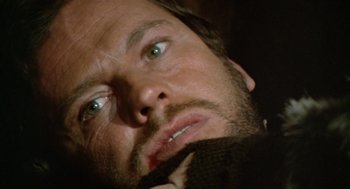 Movie still from “The Great Silence” (1968), directed by Sergio Corbucci – A man with green eyes looking up; Close Up shot, High angle