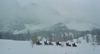 Movie still from “The Great Silence” (1968), directed by Sergio Corbucci – A group of people riding horses in the snow; Extreme Wide shot, High angle