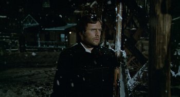 Movie still from “The Great Silence” (1968), directed by Sergio Corbucci – A man standing in the snow near a pole; Medium shot, Low angle