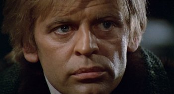 Movie still from “The Great Silence” (1968), directed by Sergio Corbucci – A man's face in a black suit; Close Up shot, Low angle