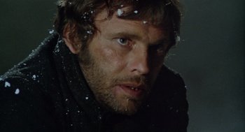 Movie still from “The Great Silence” (1968), directed by Sergio Corbucci – A person wearing a black jacket; Close Up shot, Low angle