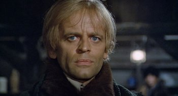 Movie still from “The Great Silence” (1968), directed by Sergio Corbucci – A person wearing a coat; Close Up shot, Low angle