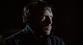 Movie still from “The Great Silence” (1968), directed by Sergio Corbucci – A person wearing a black jacket; Close Up shot, Low angle