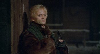 Movie still from “The Great Silence” (1968), directed by Sergio Corbucci – A man with blonde hair holding a gun in his hand; Close Up shot, Low angle