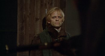 Movie still from “The Great Silence” (1968), directed by Sergio Corbucci – A man with blonde hair and a beard; Close Up shot, Over the shoulder angle
