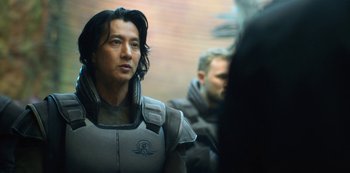 Movie still from “Altered Carbon” (2018), created by Laeta Kalogridis – A person wearing a suit; Close Up shot, Over the shoulder angle