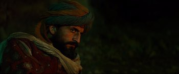 Movie still from “The Great Wall” (2016), directed by Yimou Zhang – A man with a turban on his head and a beard; Close Up shot, Over the shoulder angle