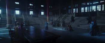 Movie still from “The Great Wall” (2016), directed by Yimou Zhang – A group of people sitting in a dark room; Wide shot, High angle