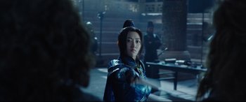 Movie still from “The Great Wall” (2016), directed by Yimou Zhang – A woman in a blue outfit standing in front of a group of people; Medium shot, Over the shoulder angle