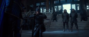 Movie still from “The Great Wall” (2016), directed by Yimou Zhang – A woman in a helmet is holding a sword in front of stairs; Wide shot, Low angle