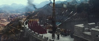 Movie still from “The Great Wall” (2016), directed by Yimou Zhang – A group of people in red robes standing in a field; Extreme Wide shot, High angle