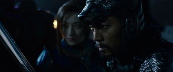 Movie still from “The Great Wall” (2016), directed by Yimou Zhang – A man and a woman are standing in a dark room; Close Up shot, Over the shoulder angle
