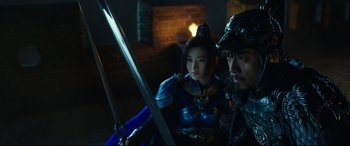 Movie still from “The Great Wall” (2016), directed by Yimou Zhang – A man and a woman holding swords in a dark room; Medium shot, Over the shoulder angle