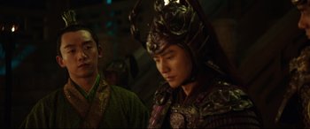 Movie still from “The Great Wall” (2016), directed by Yimou Zhang – A man in a costume is standing next to another man in a costume; Medium shot, Over the shoulder angle