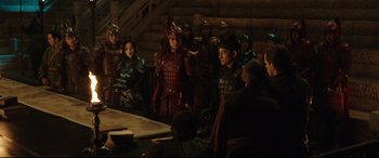 Movie still from “The Great Wall” (2016), directed by Yimou Zhang – A group of people standing around a table; Wide shot, Over the shoulder angle