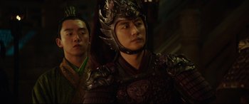 Movie still from “The Great Wall” (2016), directed by Yimou Zhang – A man in a dragon costume and another man in a dragon costume; Close Up shot, Over the shoulder angle