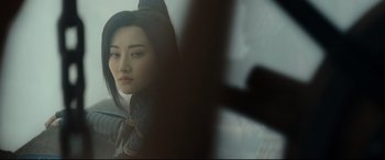 Movie still from “The Great Wall” (2016), directed by Yimou Zhang – A young asian woman sitting on a train looking out the window; Close Up shot, Over the shoulder angle