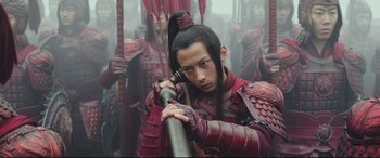 Movie still from “The Great Wall” (2016), directed by Yimou Zhang – A man in a red outfit holding a sword; Medium shot, Low angle