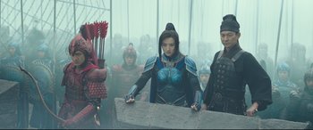 Movie still from “The Great Wall” (2016), directed by Yimou Zhang – A group of people standing in front of a wall; Medium shot, Low angle