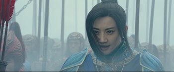 Movie still from “The Great Wall” (2016), directed by Yimou Zhang – A woman in a blue outfit standing in front of a group of people; Close Up shot, Low angle