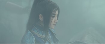 Movie still from “The Great Wall” (2016), directed by Yimou Zhang – A woman with long black hair is looking to her left; Close Up shot, Over the shoulder angle
