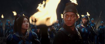 Movie still from “The Great Wall” (2016), directed by Yimou Zhang – A man is standing in front of a bunch of flames; Close Up shot, Over the shoulder angle