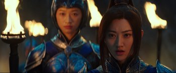 Movie still from “The Great Wall” (2016), directed by Yimou Zhang – Two women in blue and silver outfits standing next to each other; Close Up shot, Over the shoulder angle