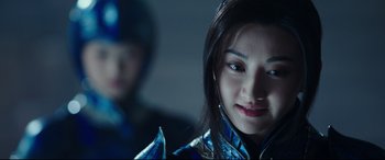 Movie still from “The Great Wall” (2016), directed by Yimou Zhang – A young woman in a blue and silver outfit; Close Up shot, Over the shoulder angle
