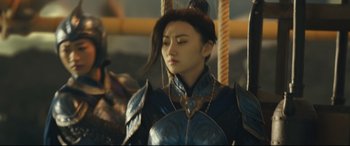 Movie still from “The Great Wall” (2016), directed by Yimou Zhang – A woman wearing a suit of armor on top of a carousel; Medium shot, Low angle