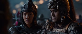 Movie still from “The Great Wall” (2016), directed by Yimou Zhang – A man and a woman wearing armor stand next to each other; Close Up shot, Over the shoulder angle