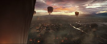 Movie still from “The Great Wall” (2016), directed by Yimou Zhang – A group of hot air balloons flying over a city at sunset; Extreme Wide shot, High angle