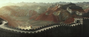 Movie still from “The Great Wall” (2016), directed by Yimou Zhang – An aerial view of a mountain range with a motorcycle driving down it; Extreme Wide shot, High angle