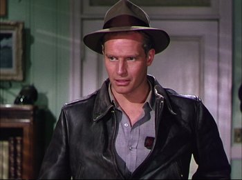Movie still from “The Greatest Show on Earth” (1952), directed by Cecil B. DeMille – A man wearing a leather jacket and a hat; Close Up shot, Over the shoulder angle
