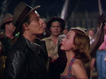 Movie still from “The Greatest Show on Earth” (1952), directed by Cecil B. DeMille – A man and a woman are standing in front of a group of people; Medium shot, Low angle