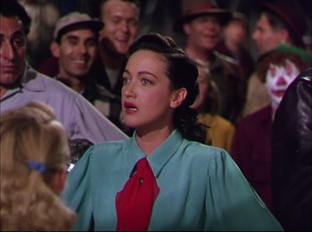 Movie still from “The Greatest Show on Earth” (1952), directed by Cecil B. DeMille – A woman in a green shirt and a red neck tie; Medium shot, Over the shoulder angle
