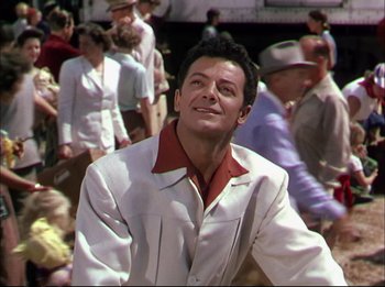 Movie still from “The Greatest Show on Earth” (1952), directed by Cecil B. DeMille – A man sitting in front of a group of people; Medium shot, Low angle