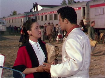 Movie still from “The Greatest Show on Earth” (1952), directed by Cecil B. DeMille – A man and a woman standing next to each other; Medium shot, Over the shoulder angle